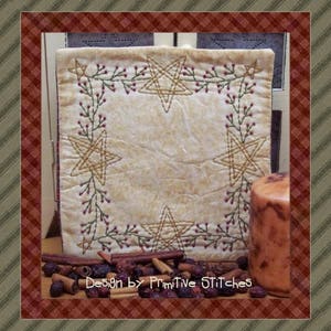 May include: A white fabric square with a hand-stitched design of stars and vines. The fabric has a vintage, worn look. The design is in shades of brown and green. The fabric is framed by a red and white checkered border.