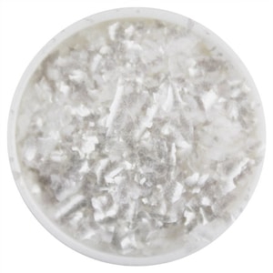 May include: A close-up of a white bowl filled with white, flaky, iridescent mica flakes.