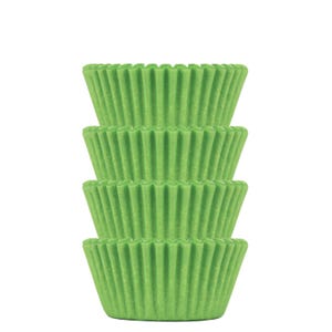 May include: A stack of four green cupcake liners. The liners are made of paper and have a fluted design.