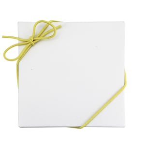 May include: A white square box with a yellow ribbon tied in a bow on top.