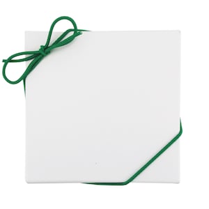 May include: A white gift box with a green ribbon tied in a bow.