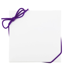 May include: A white gift box with a purple ribbon tied around it.
