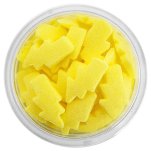 May include: A clear jar filled with yellow sugar sprinkles shaped like lightning bolts.