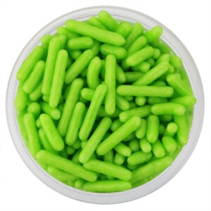 May include: A clear glass container filled with bright green sprinkles. The sprinkles are cylindrical in shape and evenly distributed throughout the container. The image is a close-up shot, highlighting the texture and color of the sprinkles.