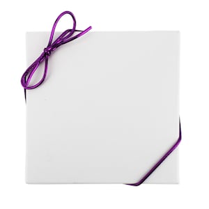 May include: A square, white gift box with a shiny, metallic purple ribbon tied around it. The ribbon forms a bow at the top left corner and follows the box's edges. The box is plain and has a simple, minimalist design.