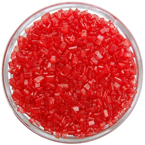 May include: A bowl of red sugar crystals, also known as sanding sugar, used for decorating cakes and other desserts.