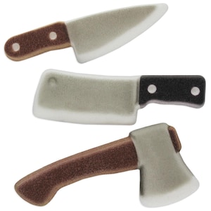 May include: Three white sugar cookie cutters shaped like kitchen knives. The cutters are a chef's knife, a cleaver, and an axe.