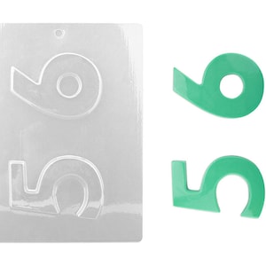 May include: A clear plastic mold for making chocolate numbers. The mold has two cavities, one for the number 9 and one for the number 5. Two green chocolate numbers, a 9 and a 5, are shown next to the mold.