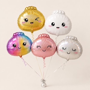May include: A set of five foil balloons shaped like rounded pouches with smiling faces. The balloons are gold, white, iridescent rainbow, pink, and silver. Each balloon features a cartoon face with eyes and a mouth, attached to curling ribbons.