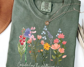 May include: A green t-shirt with a floral design and the text "Consider how the wildflowers grow Luke 12:27-28".