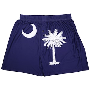 May include: A pair of blue boxer shorts with a white crescent moon and palmetto tree design, representing the South Carolina state flag.