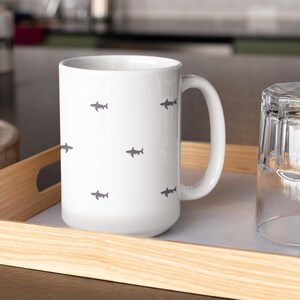 Minimalist Shark Lover Gift for Marine Biologist Mug. Great White Shark Week Cup perfect for coffee, tea, or hot drinks. Ocean animal enthusiast gift for diver, marine life researcher, or coastal home decor fan. Durable ceramic marine biologist cup is a thoughtful Shark Week gift for ocean conservation supporters, scuba divers, or shark lovers.