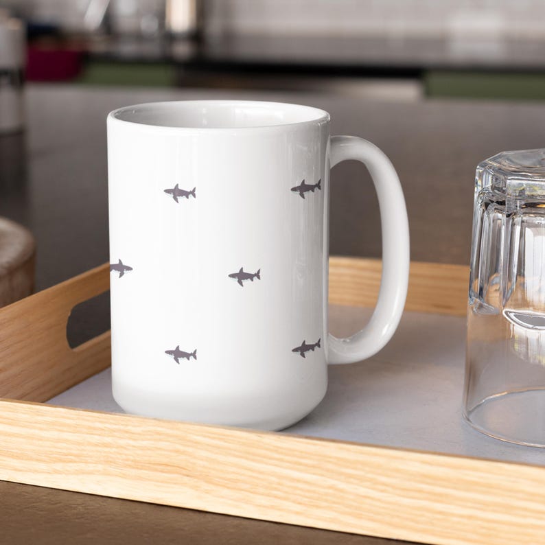 Minimalist Shark Lover Gift for Marine Biologist Mug. Great White Shark Week Cup perfect for coffee, tea, or hot drinks. Ocean animal enthusiast gift for diver, marine life researcher, or coastal home decor fan. Durable ceramic marine biologist cup is a thoughtful Shark Week gift for ocean conservation supporters, scuba divers, or shark lovers.