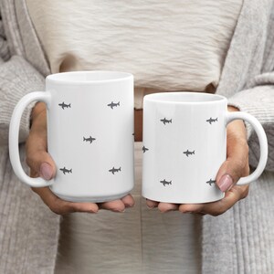 Minimalist Shark Lover Gift for Marine Biologist Cup featuring a sleek Great White Shark Week Mug. Perfect ocean animal coffee mug for marine life enthusiast, diver, or ocean explorer. Unique marine biologist gift idea for birthdays, Shark Week fans, or anyone who loves marine life. Durable ceramic shark lover cup adds a touch of coastal minimalist style to your morning coffee routine.