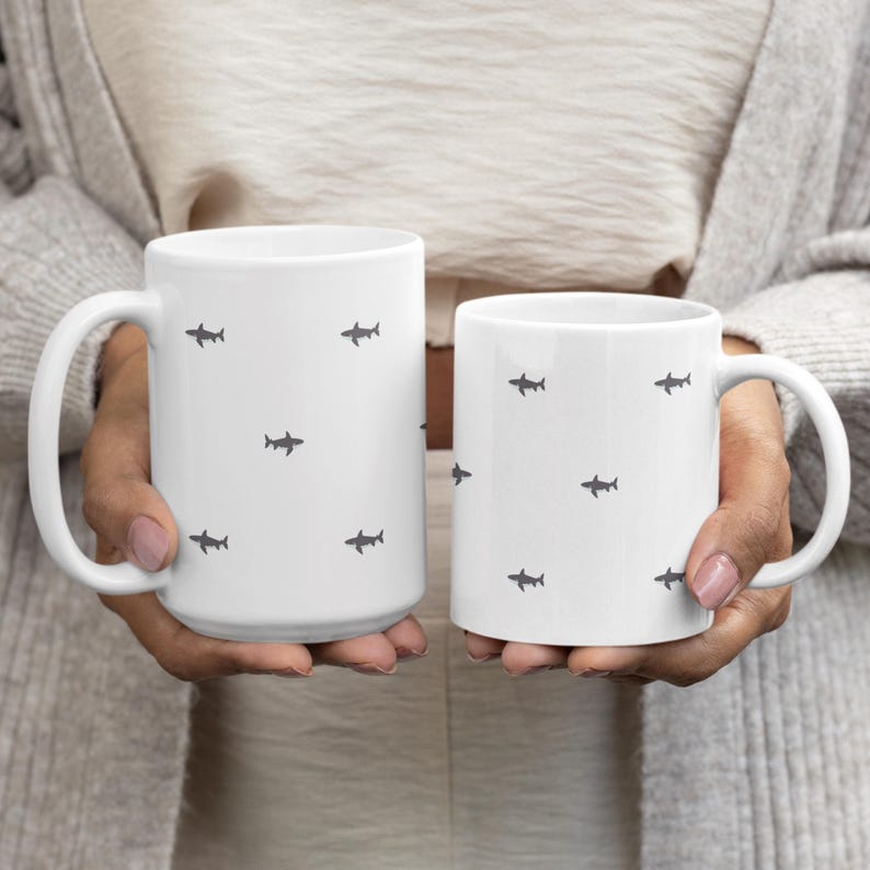 Minimalist Shark Lover Gift for Marine Biologist Cup featuring a sleek Great White Shark Week Mug. Perfect ocean animal coffee mug for marine life enthusiast, diver, or ocean explorer. Unique marine biologist gift idea for birthdays, Shark Week fans, or anyone who loves marine life. Durable ceramic shark lover cup adds a touch of coastal minimalist style to your morning coffee routine.
