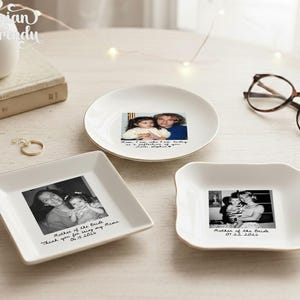 May include: Three white ceramic trinket dishes featuring personalized black and white photographs and handwritten-style text. One round dish and two square dishes display family photos with inscriptions including dates and messages like Mother of the Bride.