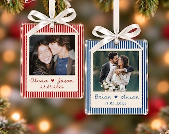 May include: Two rectangular acrylic ornaments with white satin ribbons. The left ornament has red vertical stripes, a photo of a couple, and text reading Olivia, Jason, and 23.03.2026. The right has blue stripes, a photo of a couple, and Brian, Susan, 18.05.2026.