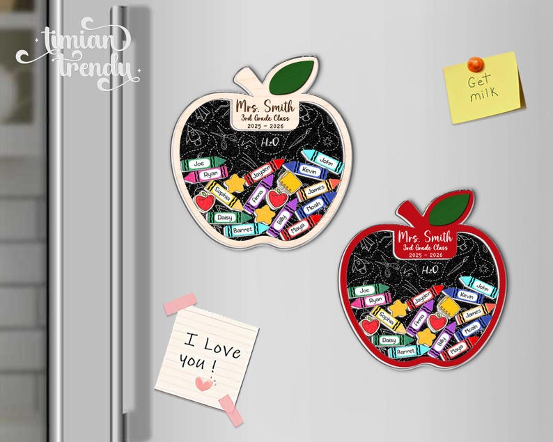 May include: Two apple-shaped magnets with a chalkboard design, filled with crayon-shaped name tags. One magnet is red, the other is beige. Both magnets have the text "Mrs. Smith 3rd Grade Class 2025-2026". A sticky note says "Get milk".