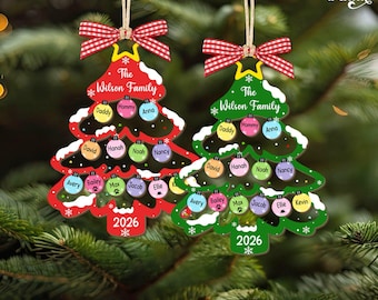 May include: Two Christmas tree-shaped ornaments with red and green borders, featuring the text The Wilson Family and 2026. Each ornament displays multiple small circular name tags including Daddy, Mommy, Anna, David, Hanah, Noah, Nancy, Avery, Bailey, Max, Jacob, Ellie, and Kevin.