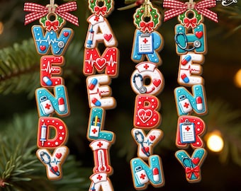 May include: Four vertical hanging ornaments shaped like gingerbread cookies, each featuring medical-themed graphics like stethoscopes, syringes, and charts. The names WENDY, AMELIA, ROBYN, and HENRY are spelled out in colorful, decorated letters.