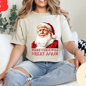 サンタがアメリカを再び偉大にするシャツ、トランプのクリスマスシャツ、トランプのサンタTシャツ、共和党のクリスマスTシャツ、クリスマスを再び偉大にする