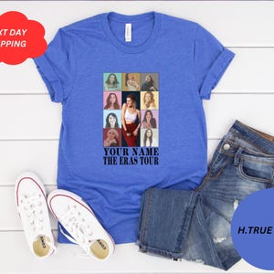 May include: A royal blue t-shirt with a collage of photos of a woman in different outfits and hairstyles. The text "YOUR NAME THE ERAS TOUR" is printed below the collage.