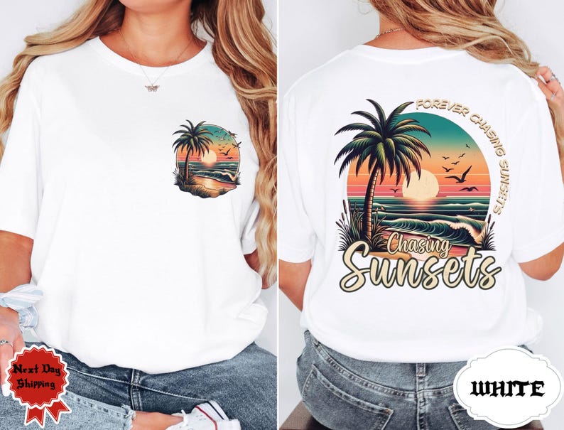 May include: White t-shirt with a colorful sunset graphic. The front features a small design of a palm tree, ocean, and sunset. The back has a larger design with the text "Forever Chasing Sunsets" and "Chasing Sunsets".