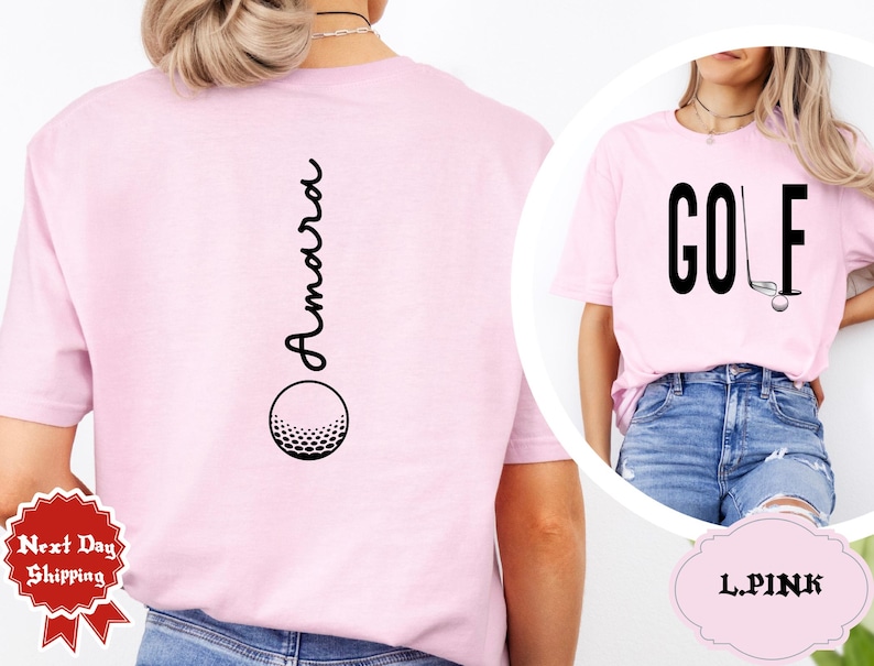 May include: Light pink t-shirts with golf-themed designs. One shirt features the word "GOLF" with a golf club and ball graphic. The other shirt has the name "Amara" vertically with a golf ball graphic.