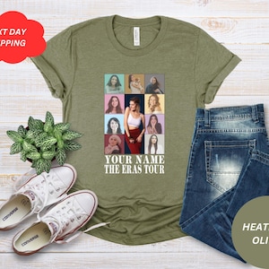 May include: A green t-shirt with a collage of photos of a woman in different outfits. The text "YOUR NAME THE ERAS TOUR" is printed on the shirt.