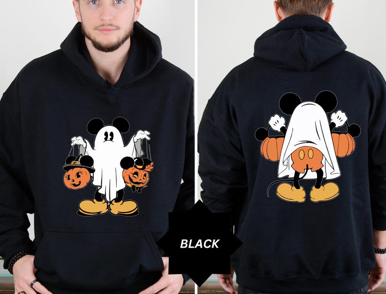 May include: Black Halloween hoodie featuring a cartoon character dressed as a ghost, holding pumpkin-shaped treat bags. The design includes orange pumpkins and the text "BLACK". The back of the hoodie shows the character with pumpkins.