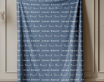 May include: A blue blanket featuring a repeating pattern of the names "Lucas Daniel" in white cursive script. The blanket is displayed, highlighting the design and texture of the fabric. The overall aesthetic is simple and elegant.