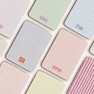 May include: A selection of rectangular items with vertical stripes in pastel shades. Each item is personalised with embroidered initials or names, including "MP", "KATE", and "EVA".