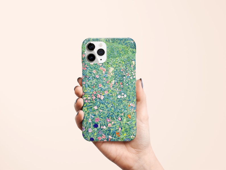 May include: A phone case featuring a floral design with a green background and colorful flowers. The case has a glossy finish and a camera cutout. The design is reminiscent of a painting.