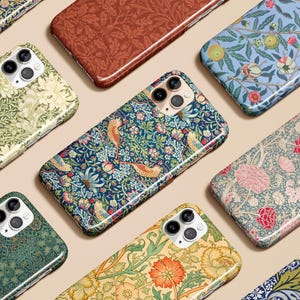 May include: A collection of phone cases with floral and botanical patterns. The cases feature various designs, including birds, flowers, and leaves, in a range of colors such as blue, green, red, and yellow. The cases are arranged on a neutral background.