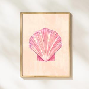 May include: A framed print featuring a pink seashell with a textured, watercolour-like design. The seashell is the central element of the image, set against a pale peach background.
