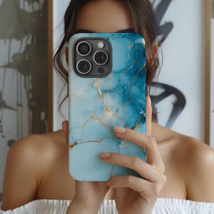 May include: A blue and gold marble phone case with a camera lens cutout.