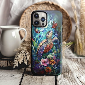May include: A phone case featuring a colorful mosaic design of a sea turtle amidst flowers and foliage. The case has a black border and a glossy finish, with a vibrant palette of blues, greens, purples, and oranges. The design includes butterflies and a stained-glass effect.