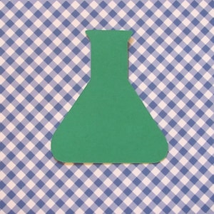May include: A green paper cutout of a beaker or flask on a blue and white gingham background.