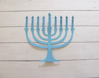 May include: A light blue menorah with nine candles, a traditional symbol of Hanukkah.