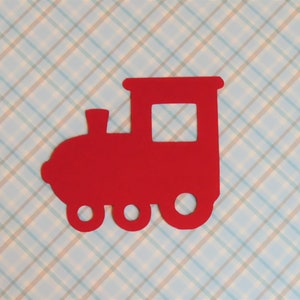 May include: Red paper cutout of a train engine with a single window and three wheels.