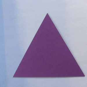 May include: A purple triangle made of paper.