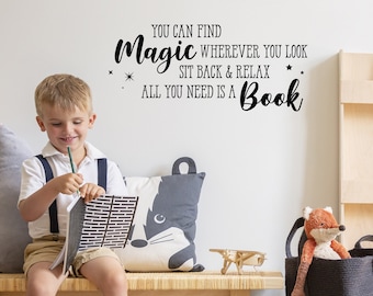 May include: A boy sits on a bench reading a book. The wall behind him has a black and white quote that reads "You can find magic wherever you look. Sit back & relax. All you need is a book."