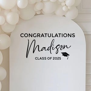 May include: White backdrop with black text that reads "Congratulations Madison Class of 2025" with a graduation cap icon.