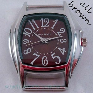 May include: A silver watch with a brown face and white Roman numeral hour markers. The watch face also has a smaller circle with the word "NARMI" printed on it.