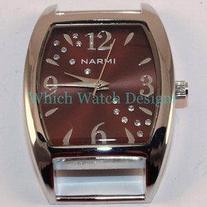 May include: A silver watch with a brown face and silver hands. The watch has a rectangular face with rounded corners and a silver band. The face has a silver 12, 3, 6, and 9, and the word "NARMI" is printed in silver at the top of the face.