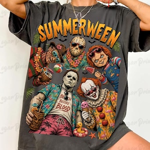 May include: A charcoal gray t-shirt featuring a graphic print with the text SUMMERWEEN. The design displays five horror movie characters in tropical attire, including a hockey mask figure, a clown, and a man in a shirt reading BEACH before BLOOD.