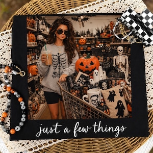 May include: A black rectangular frame featuring the white text 'just a few things' at the bottom. The frame displays a photograph of a person in a grey skeleton sweatshirt holding a coffee, standing behind a shopping cart filled with Halloween decor.