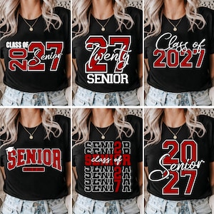 May include: A collection of six black t-shirts featuring various graphic designs for the Class of 2027. Each shirt displays red and white text including phrases like Class of 2027, Senior, and Twenty Seven in different fonts and layouts.