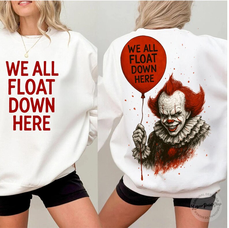 May include: White sweatshirt with the text "WE ALL FLOAT DOWN HERE" in red on the front. The back features a red balloon with the same text and a graphic of a smiling clown with red hair.