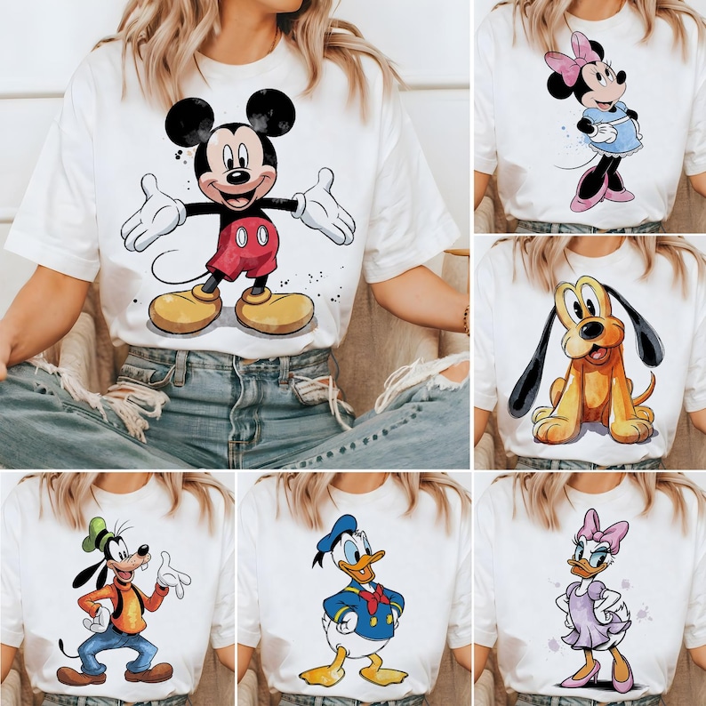 May include: Six white t-shirts with different Disney character designs. The designs include Mickey Mouse, Minnie Mouse, Pluto, Donald Duck, and Daisy Duck.